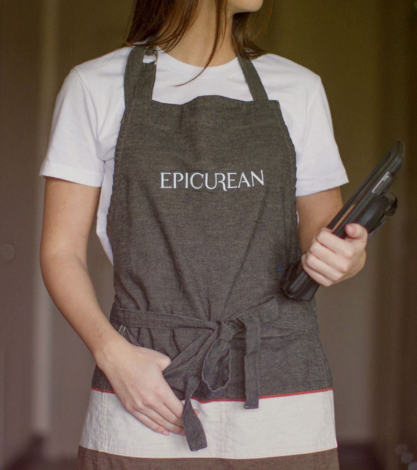 woman in Epicurean Hotel branded server apron