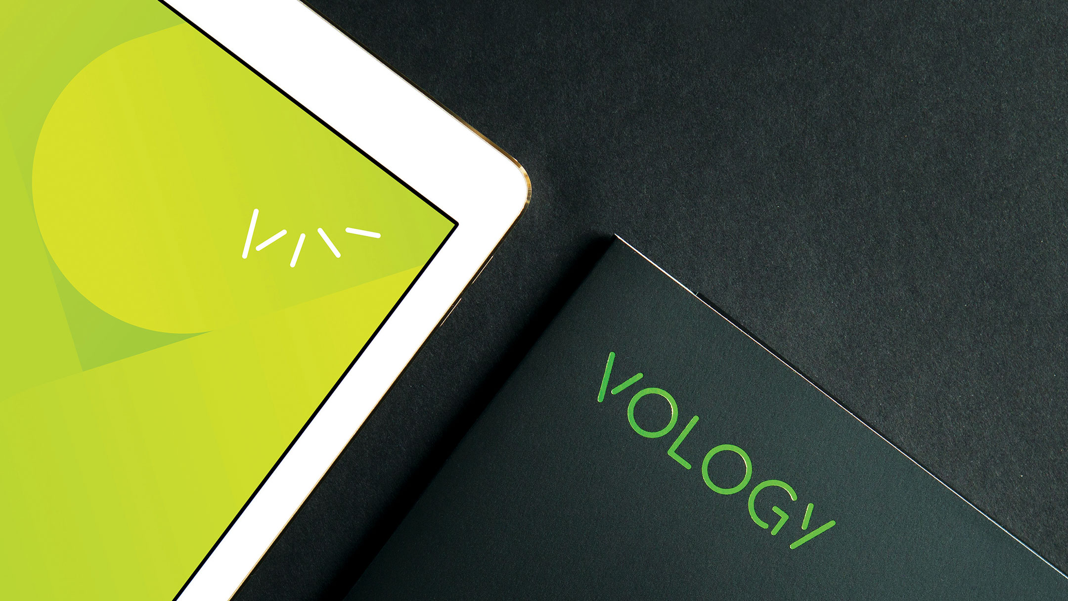 Vology logo on folder and brand mark on iPad.