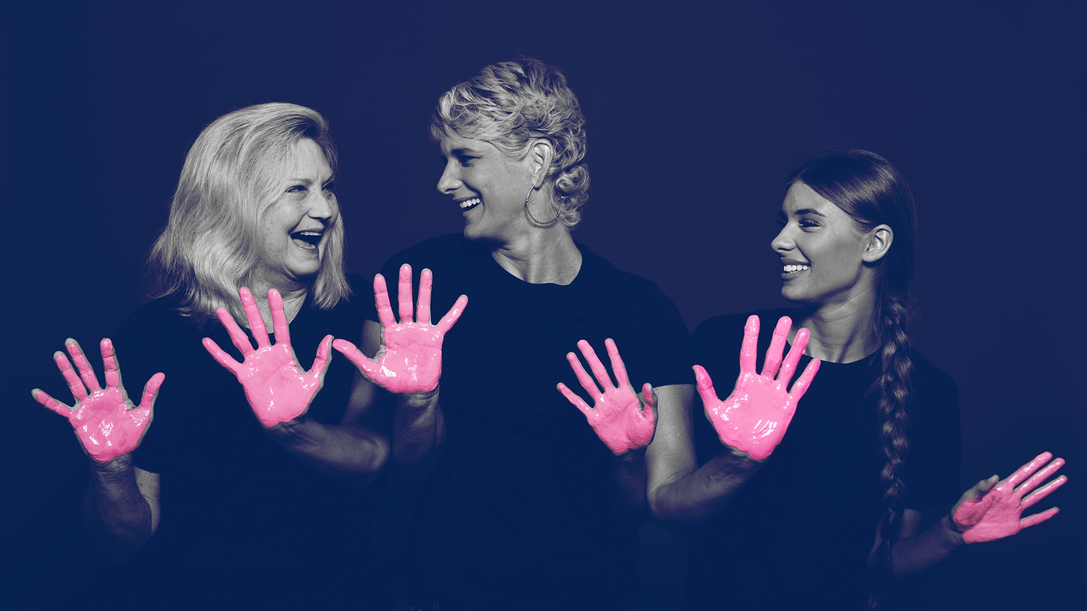 A breast cancer survivor and her family posing for the in our hands campaign with pink paint on their hands. BayCare Hospital Marketing campaign