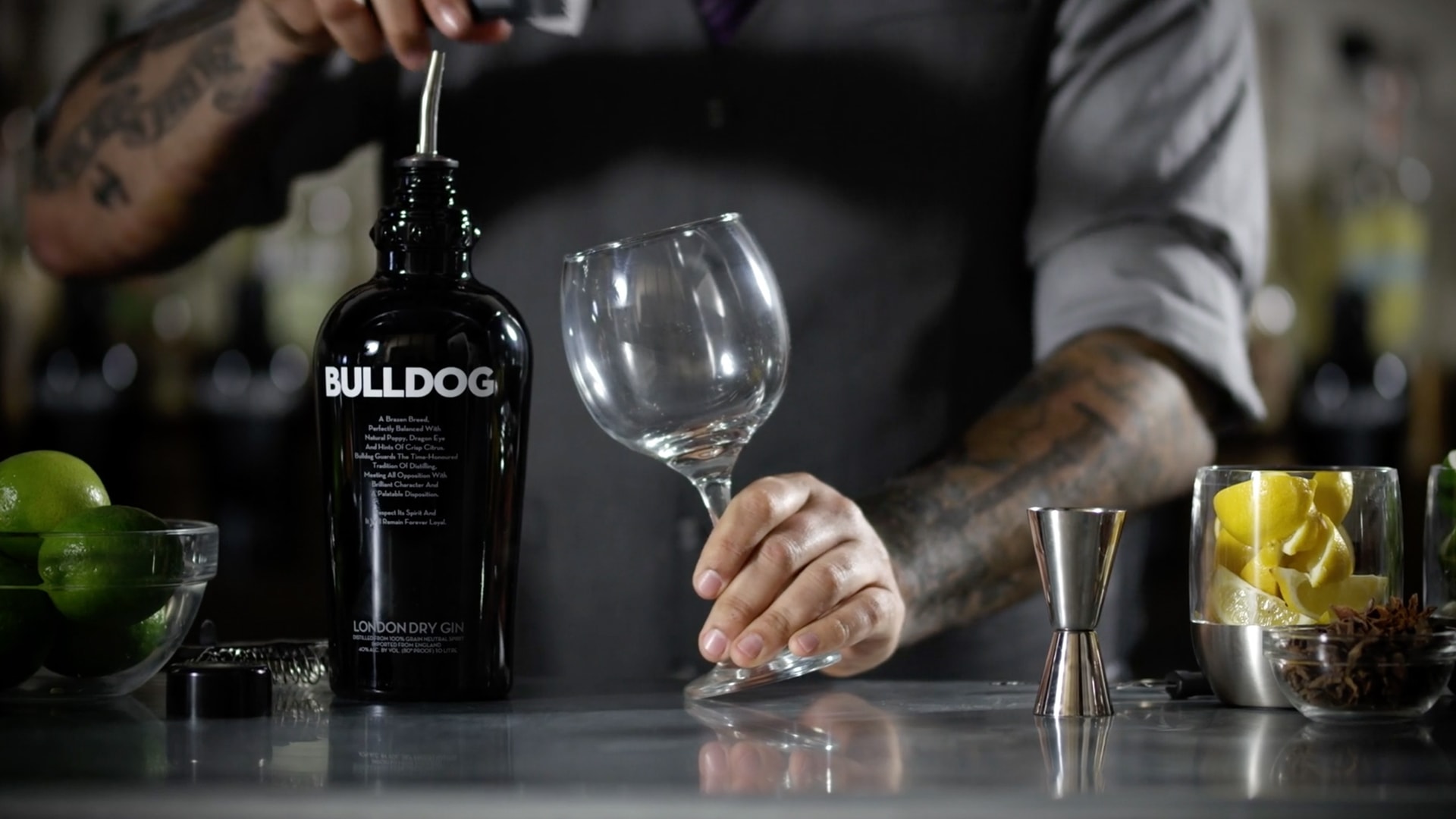 A bartender about to make a drink with bulldog gin.